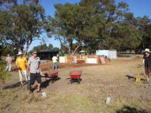 People clearing the ground to make a garden