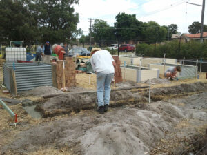 A group of people building garden beds