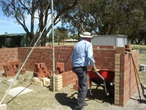 Person building a compost bay