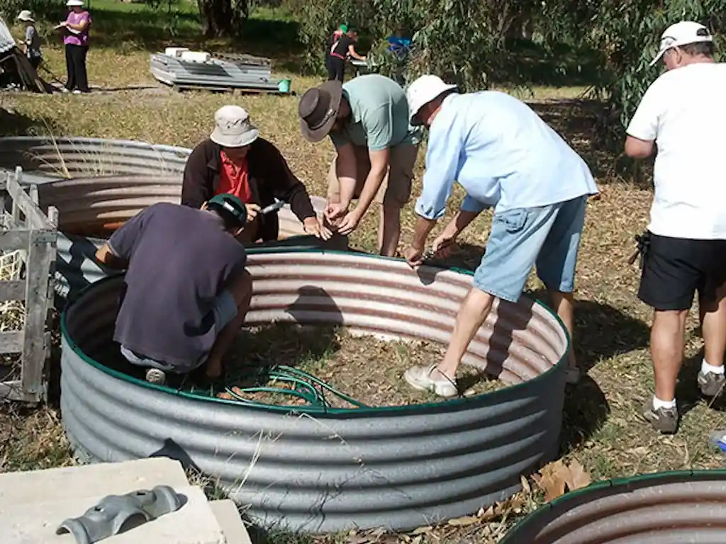 A group of people building a garden bed