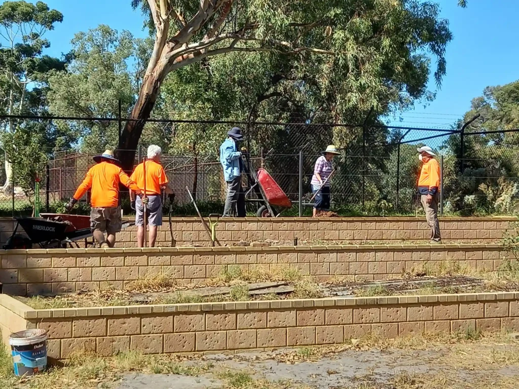 A group of people building a raised garden bed