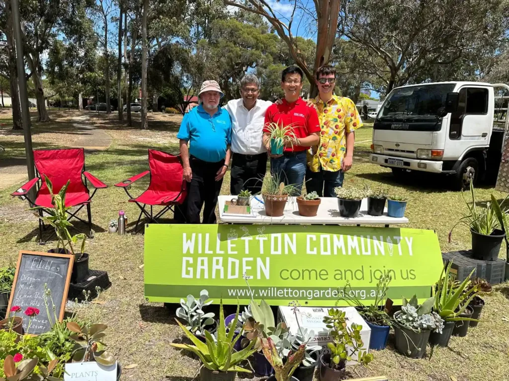 A group of people selling plants at a market stall