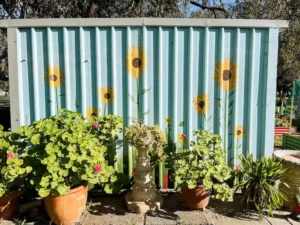 A shed with a sunflower mural