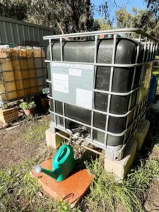 A large black tank used for collecting rain water